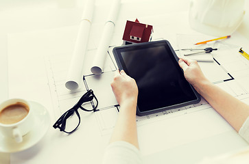 Image showing close up of hand with blueprint and tablet pc