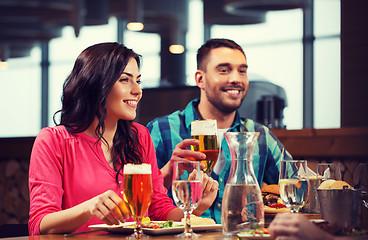 Image showing friends dining and drinking beer at restaurant