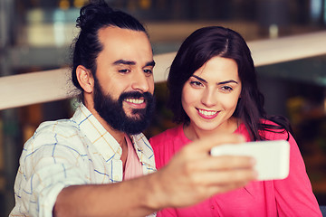 Image showing couple taking selfie by smartphone at restaurant