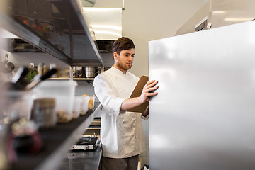 Image showing chef with clipboard doing inventory at kitchen