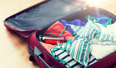 Image showing close up of travel bag with beach clothes