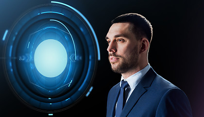 Image showing businessman with virtual projection over black