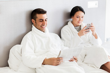 Image showing happy couple in bed at home or hotel room