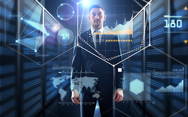 Image showing businessman with charts on virtual screen