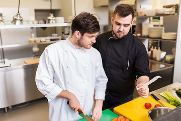 Image showing two chefs cooking food at restaurant kitchen