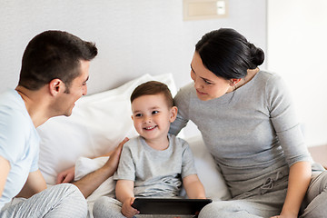 Image showing happy family with tablet pc in bed at home