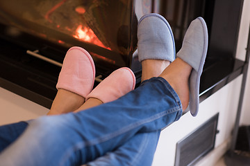 Image showing Young couple  in front of fireplace