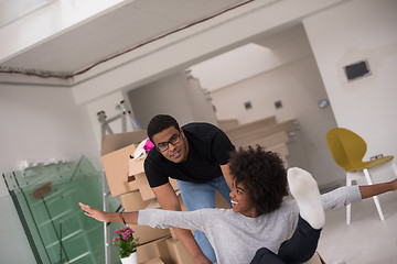 Image showing African American couple  playing with packing material