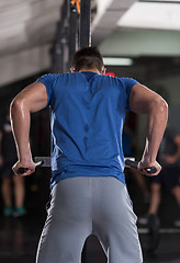 Image showing man doing exercises parallel bars