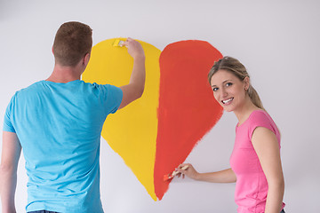 Image showing couple are painting a heart on the wall