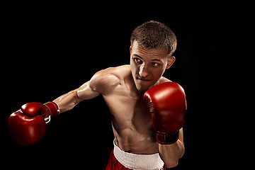 Image showing Male boxer boxing with dramatic edgy lighting in a dark studio