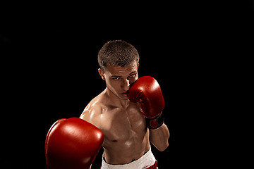 Image showing Male boxer boxing with dramatic edgy lighting in a dark studio