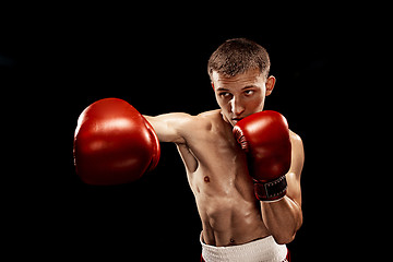 Image showing Male boxer boxing with dramatic edgy lighting in a dark studio