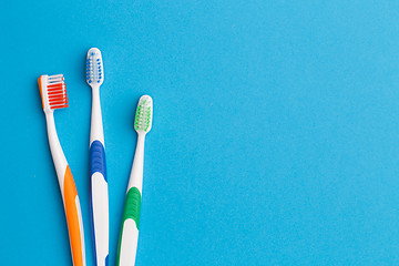 Image showing Three toothbrushes , space for text