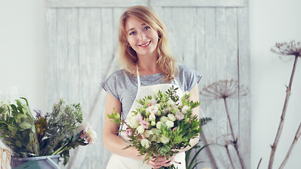 Image showing Florists woman working with flowers