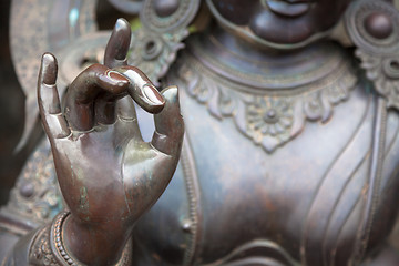 Image showing Detail of Buddha statue with Karana mudra hand position