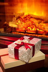 Image showing Christmas gift box with near fireplace