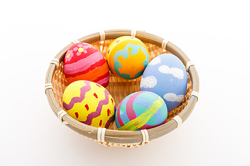 Image showing Handmade easter eggs in a basket