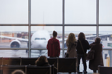 Image showing People waiting for airplane departure on a rainy day.