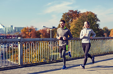 Image showing happy couple running outdoors