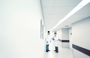 Image showing male doctors with clipboard at hospital corridor