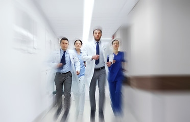 Image showing group of medics walking along hospital