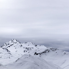 Image showing Gray snowy mountains in evening