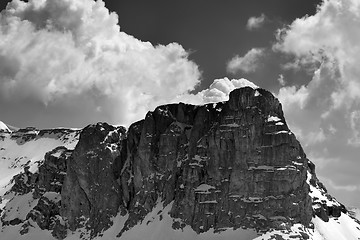 Image showing Black and white view on snow rocks and sky with clouds