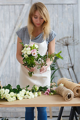 Image showing Photo of florist making bouquet