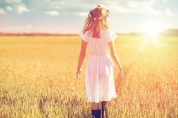 Image showing happy young woman in flower wreath on cereal field