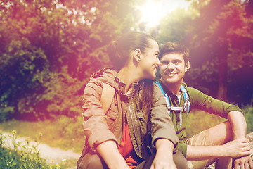 Image showing smiling couple with backpacks in nature