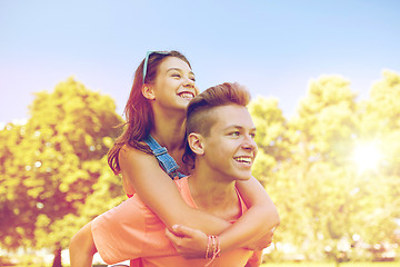 Image showing happy teenage couple having fun at summer park