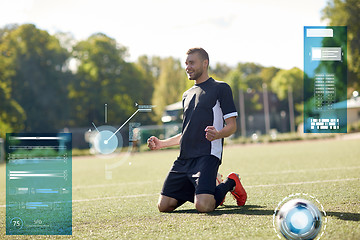 Image showing happy soccer player with ball on football field