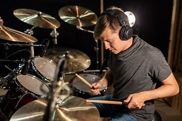 Image showing male musician playing drums and cymbals at concert