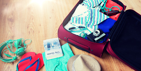 Image showing close up of travel bag with clothes and stuff