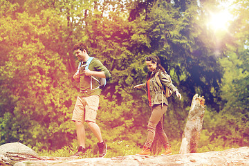 Image showing happy couple with backpacks hiking outdoors