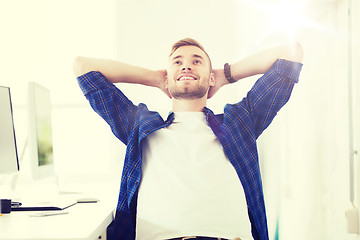 Image showing happy creative man with computer at office