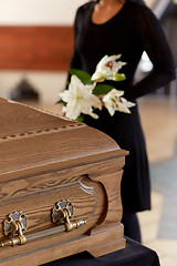 Image showing woman with flowers and coffin at funeral