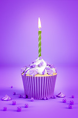 Image showing purple cupcake with a green candle