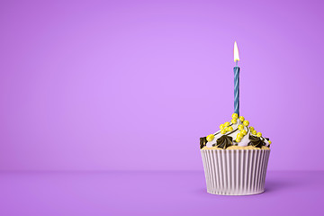 Image showing purple cupcake with a candle