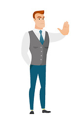 Image showing Caucasian businessman showing stop hand gesture.