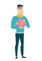 Image showing Caucasian business man holding a piggy bank.