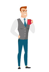 Image showing Young caucasian businessman holding cup of coffee.