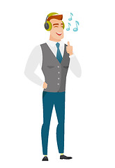 Image showing Businessman listening to music in headphones.