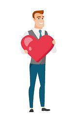 Image showing Caucasian business man holding a big red heart.