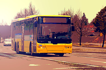 Image showing Yellow City Bus Moving in Street Traffic