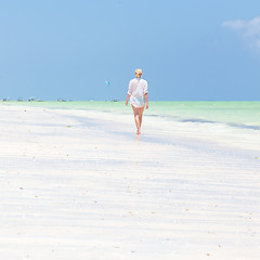 Image showing Happy woman having fun, enjoying summer, running along white tropical beach.