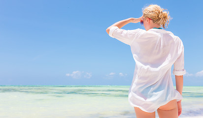 Image showing Happy woman enjoying, relaxing joyfully in summer on tropical beach.