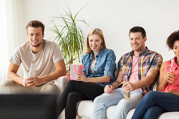 Image showing happy friends with popcorn watching tv at home