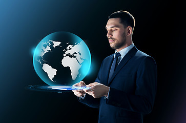 Image showing businessman with tablet pc and earth projection